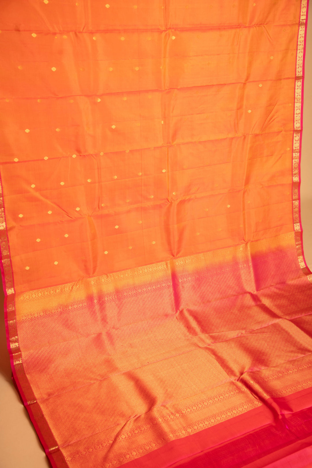 Dual tone orange and pink small border pure silk saree