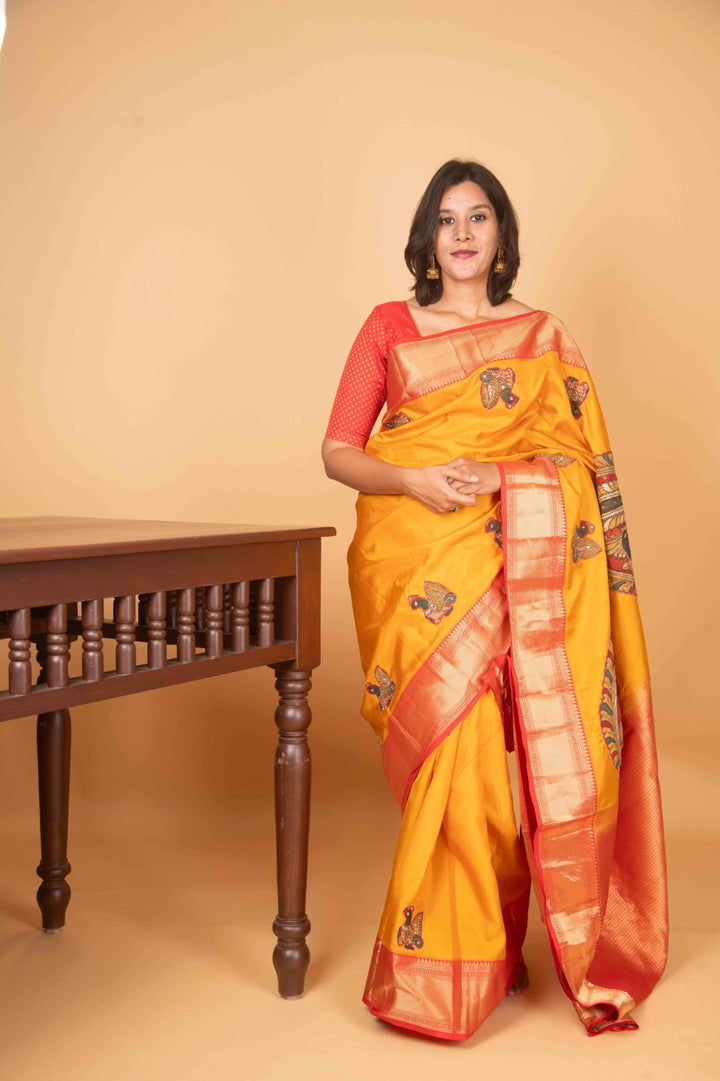 Yellow and red kalamkari embellished pure kanchi silk saree