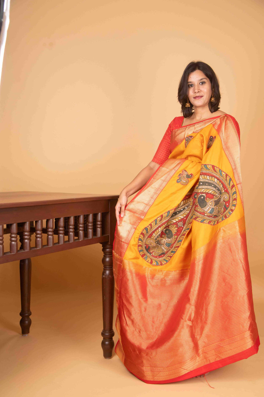 Yellow and red kalamkari embellished pure kanchi silk saree