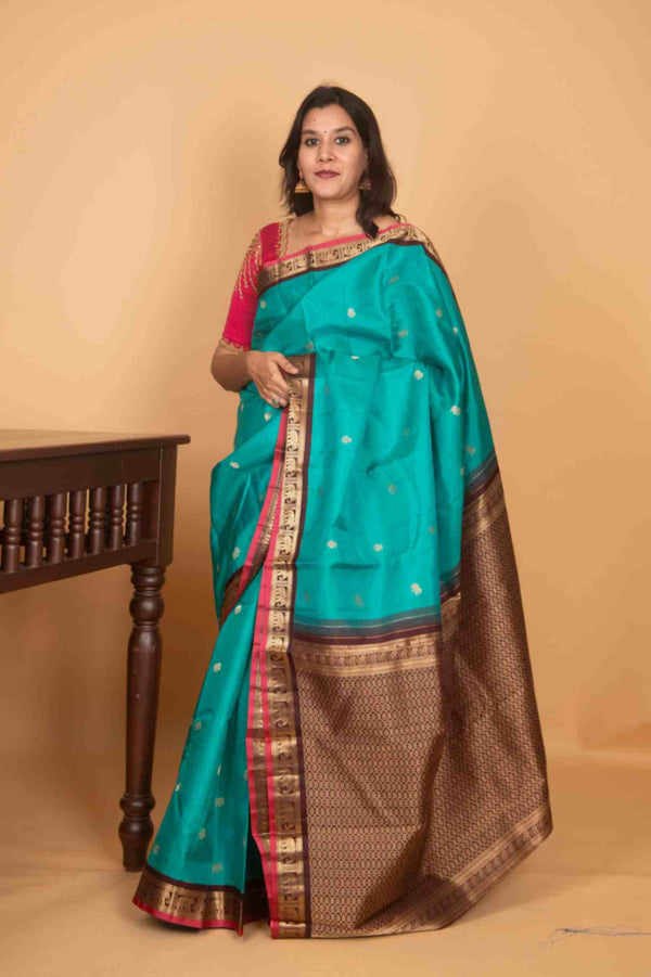 Aqua marine green and brown small border korvai silk saree