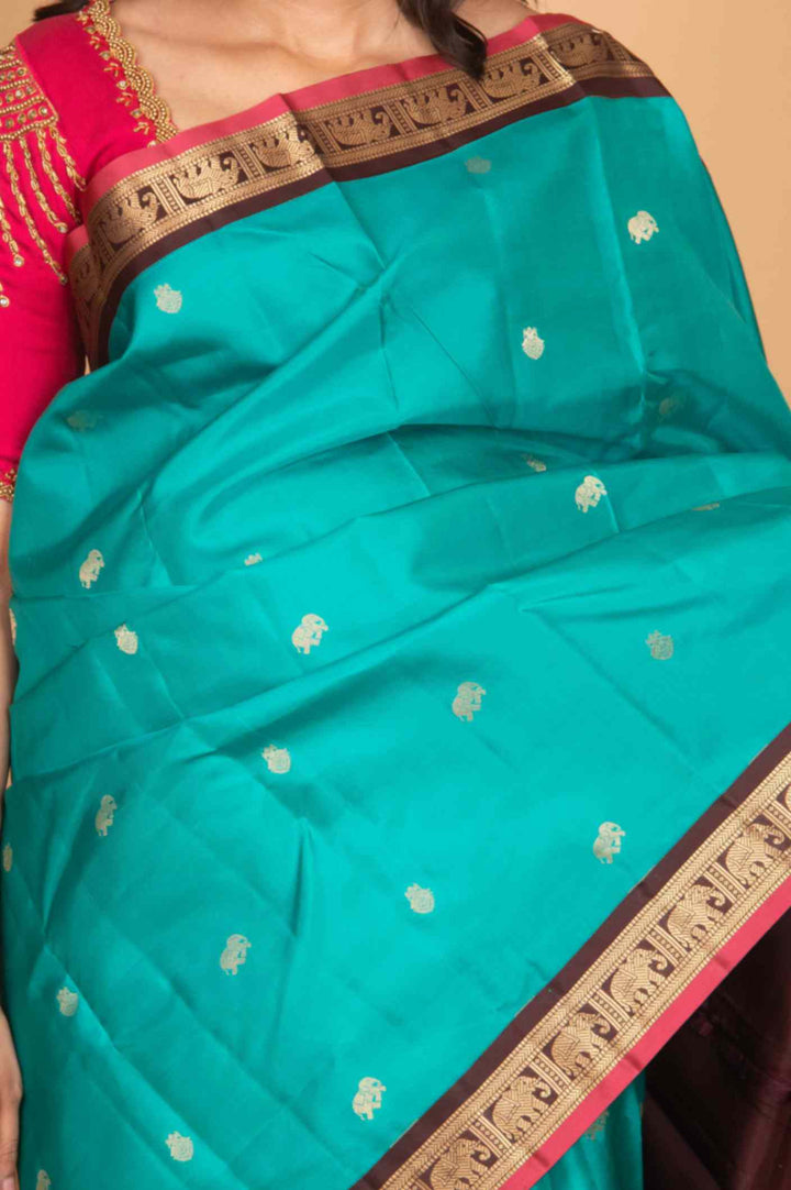 Aqua marine green and brown small border korvai silk saree