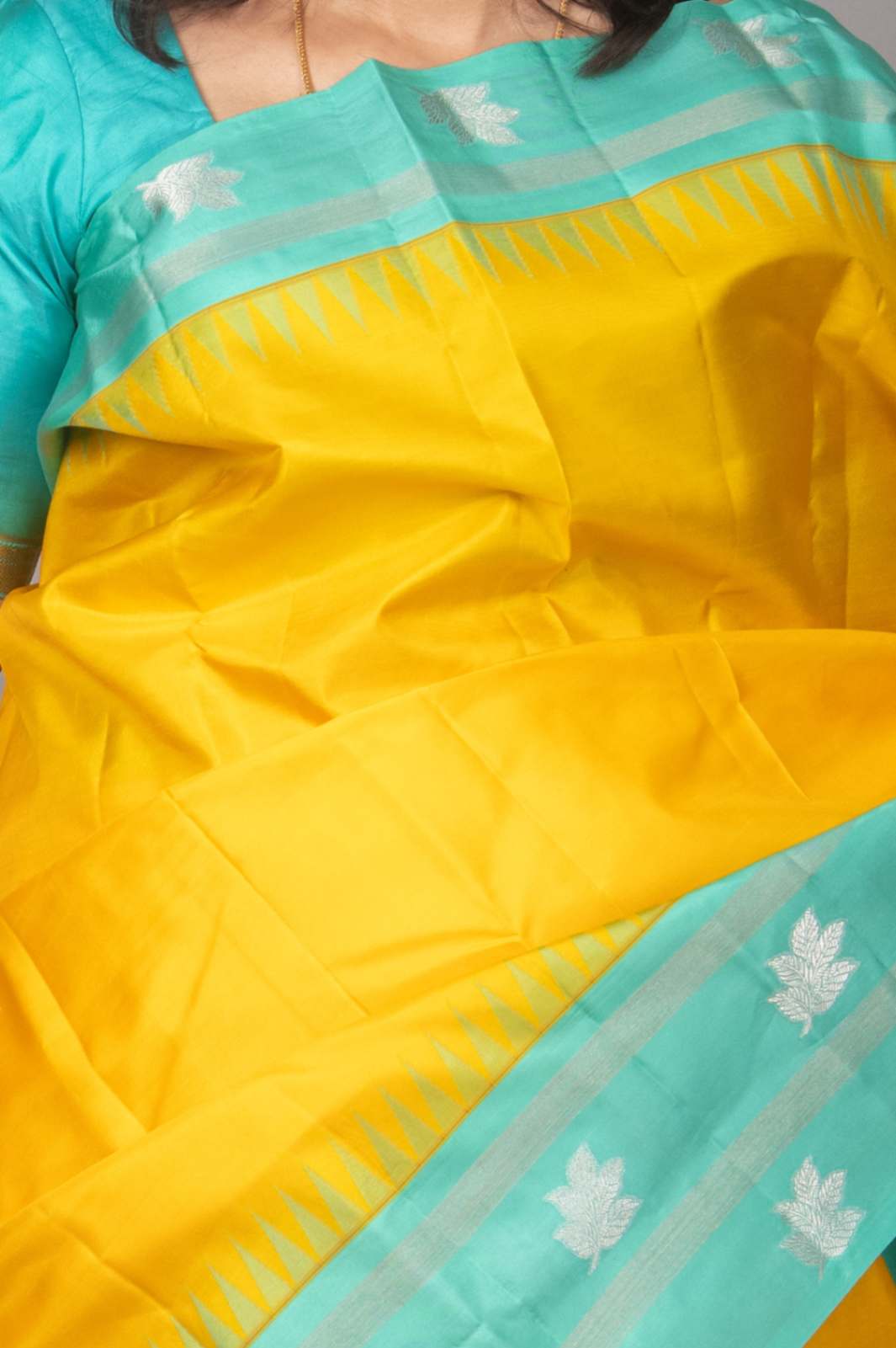 Yellow and turquoise korvai silk saree