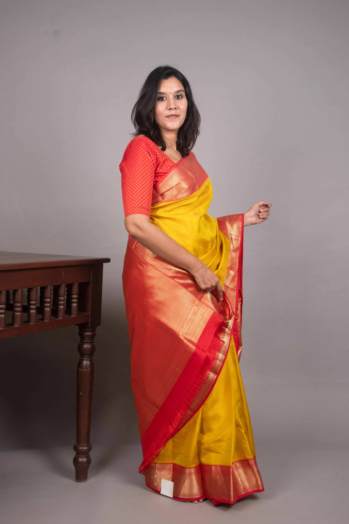 Saffron Yellow and Red Needle Embroidery Fusion silk saree